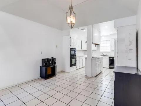 5910 Buffridge Trail Dallas, TX 75252 - Photo 18 of 24 a kitchen with a stove a refrigerator and a sink