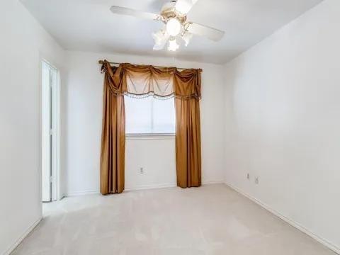 5910 Buffridge Trail Dallas, TX 75252 - Photo 20 of 24 an empty room with a mirror and a fan