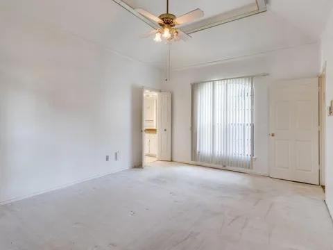 5910 Buffridge Trail Dallas, TX 75252 - Photo 21 of 24 an empty room with chandelier fan and windows