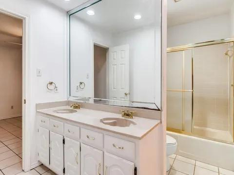 5910 Buffridge Trail Dallas, TX 75252 - Photo 23 of 24 a bathroom with a sink and a mirror