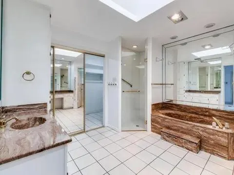 a spacious bedroom with a bed and a walk in closet