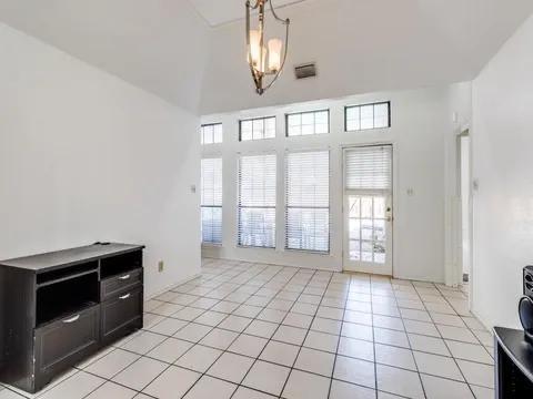 5910 Buffridge Trail Dallas, TX 75252 - Photo 6 of 24 a view of an empty room with a fireplace and a window
