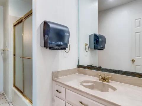 5910 Buffridge Trail Dallas, TX 75252 - Photo 7 of 24 a bathroom with a sink and a mirror