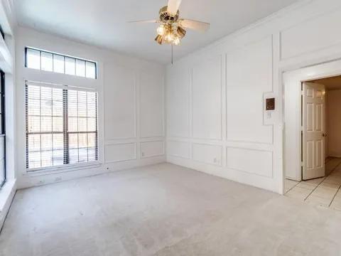 5910 Buffridge Trail Dallas, TX 75252 - Photo 8 of 24 an empty room with chandelier fan and windows