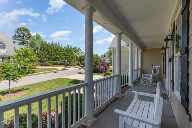a view of a patio with table and chairs and potted plants