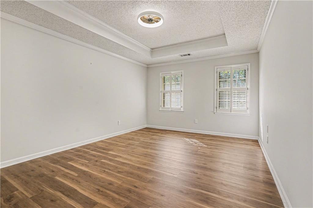 1527 Ridgewood Drive Southwest Lilburn, GA 30047 - Photo 12 of 19 wooden floor in an empty room with a window