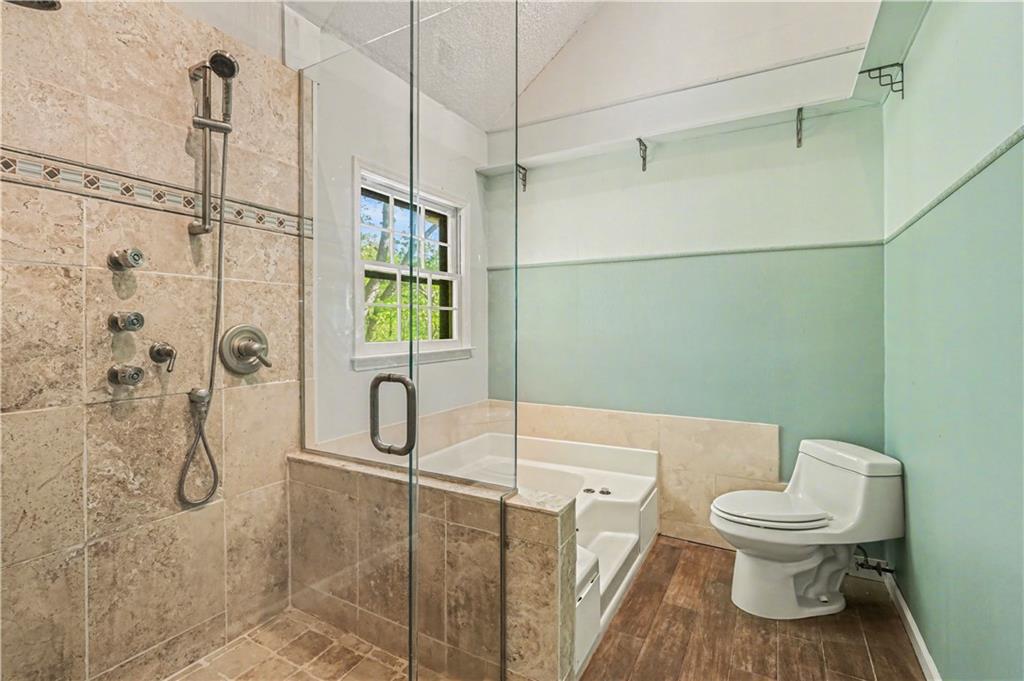 1527 Ridgewood Drive Southwest Lilburn, GA 30047 - Photo 14 of 19 a bathroom with a toilet sink and shower