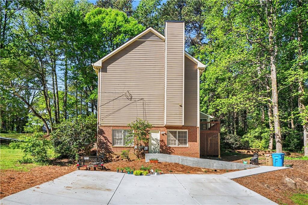1527 Ridgewood Drive Southwest Lilburn, GA 30047 - Photo 2 of 19 a backyard of a house with outdoor seating