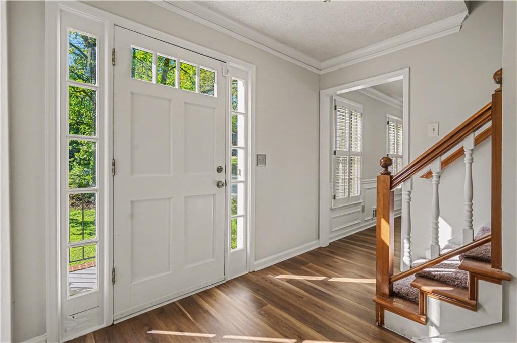 1527 Ridgewood Drive Southwest Lilburn, GA 30047 - Photo 5 of 19 a view of an entryway with wooden floor and door