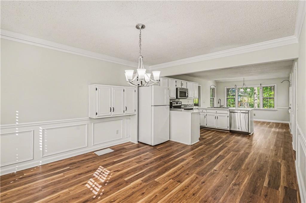 1527 Ridgewood Drive Southwest Lilburn, GA 30047 - Photo 10 of 19 a view of a kitchen with wooden floor and window