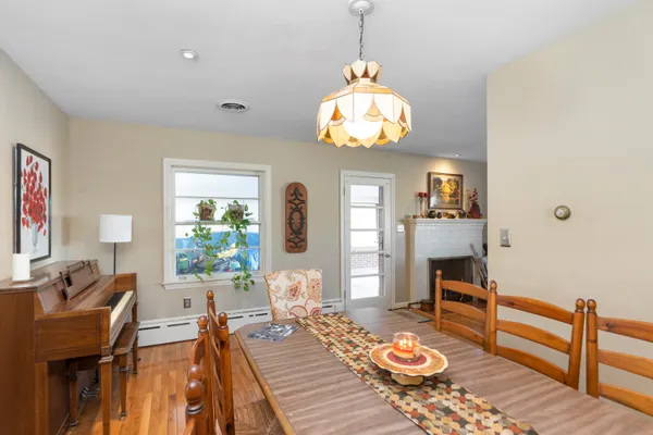a view of a dining room with furniture a chandelier and wooden floor