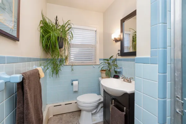 a bathroom with a sink toilet and mirror