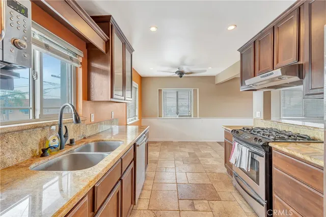 a kitchen that has a sink and a stove