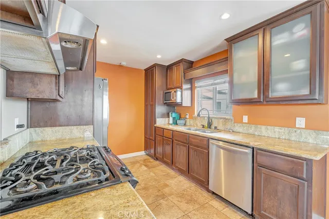 a kitchen with a stove a sink and a refrigerator