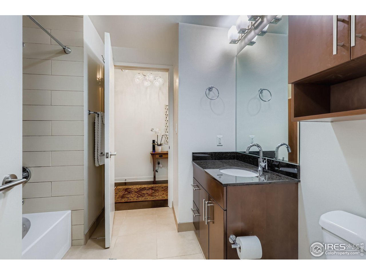 891 14th Street, Unit 1111 Denver, CO 80202 - Photo 12 of 38 a bathroom with a granite countertop sink a toilet and shower