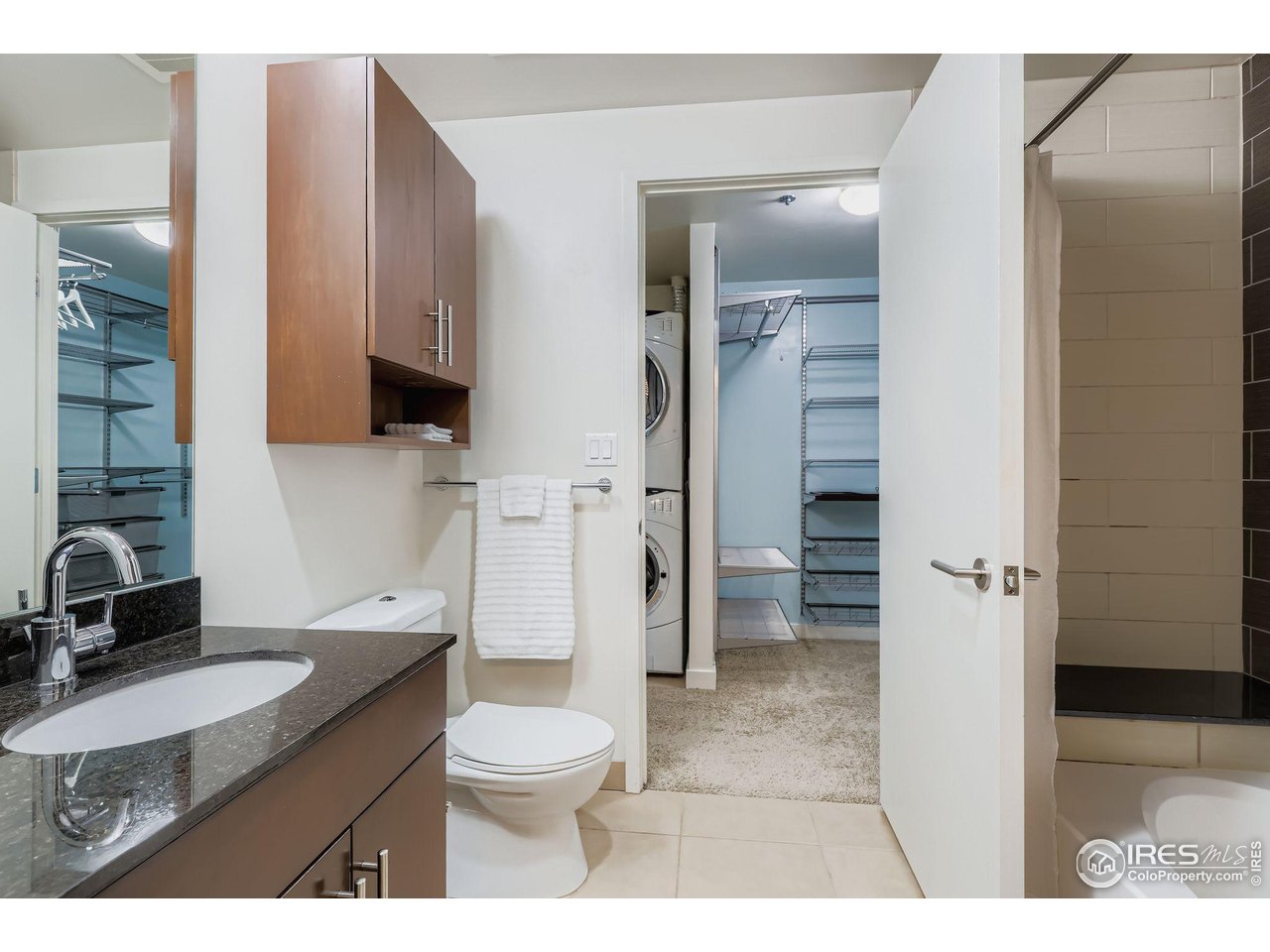 891 14th Street, Unit 1111 Denver, CO 80202 - Photo 13 of 38 a bathroom with a granite countertop sink toilet and shower