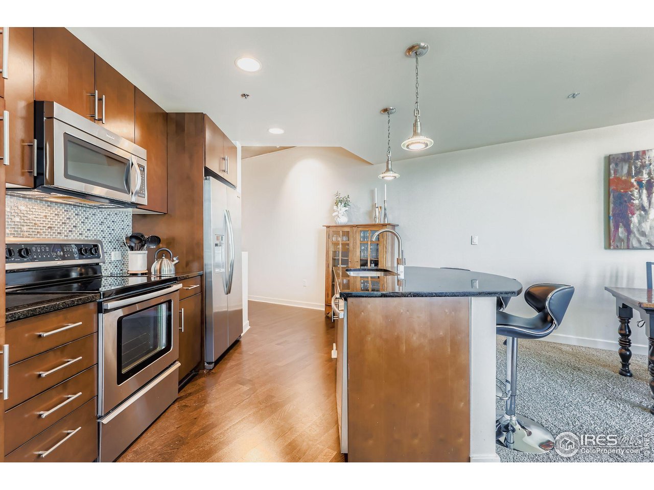 891 14th Street, Unit 1111 Denver, CO 80202 - Photo 5 of 38 a kitchen with stainless steel appliances granite countertop a sink a stove and a microwave