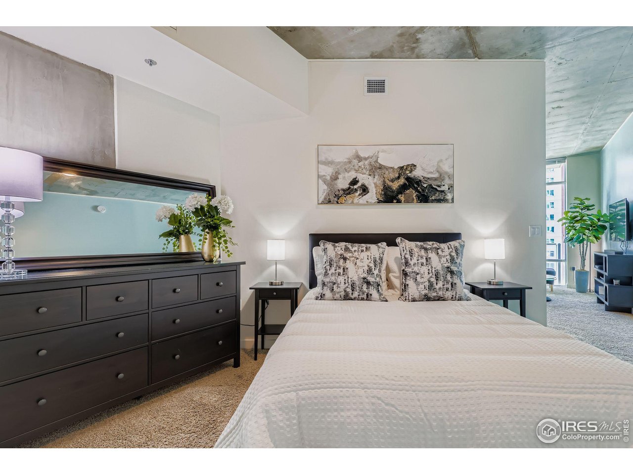 891 14th Street, Unit 1111 Denver, CO 80202 - Photo 9 of 38 a bedroom with a bed and a potted plant on dresser