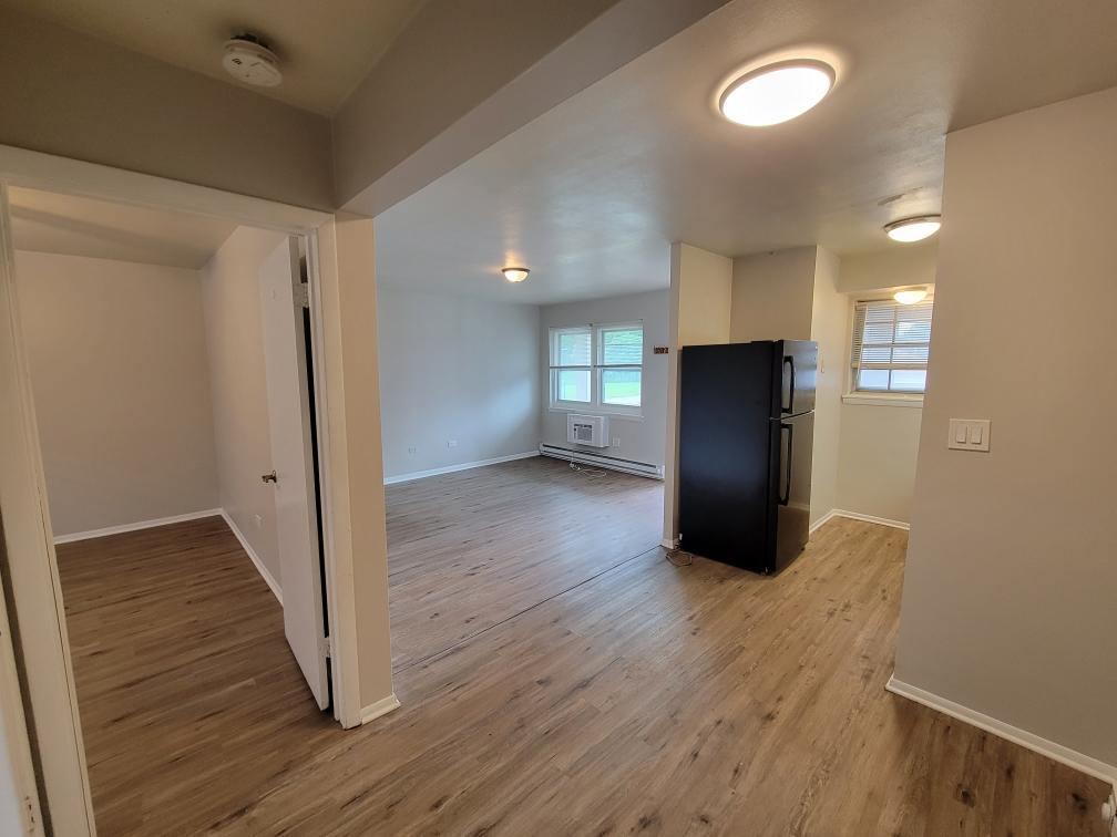 6048 West Pershing Road, Unit 8 Cicero, IL 60804 - Photo 5 of 7 a view of empty room with wooden floor