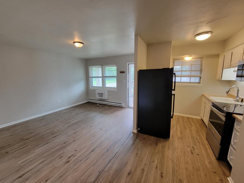 6048 West Pershing Road, Unit 8 Cicero, IL 60804 - Photo 6 of 7 a view of a kitchen with a refrigerator and wooden floor