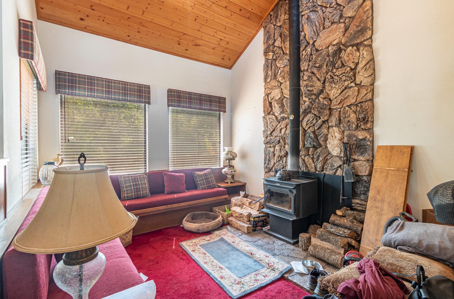 48908 Rock Point Road Oakhurst, CA 93644 - Photo 8 of 23 Step down family room with cozy free standing wood stove.