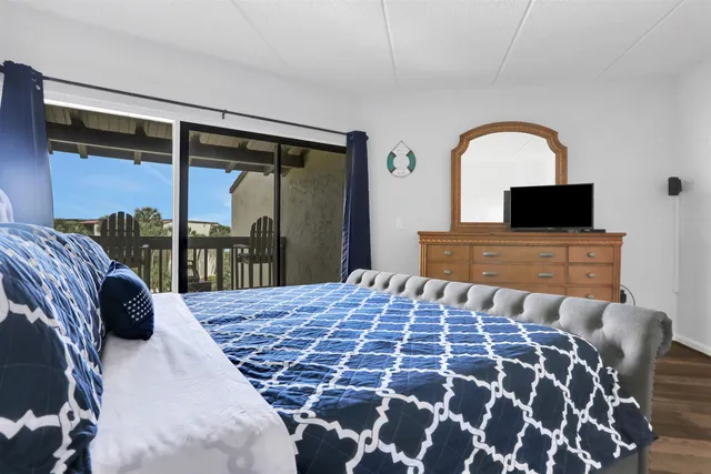 a bedroom with a large bed and a flat screen tv