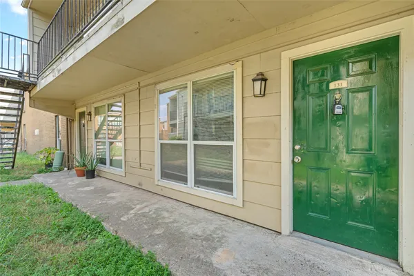 a view of front door of a house and a yard