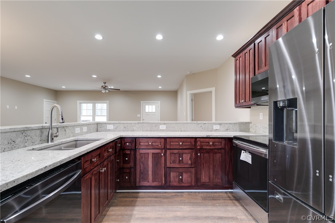 3800 Three Chopt Road Gum Spring, VA 23065 - Photo 8 of 22 a kitchen with stainless steel appliances granite countertop a sink and a refrigerator