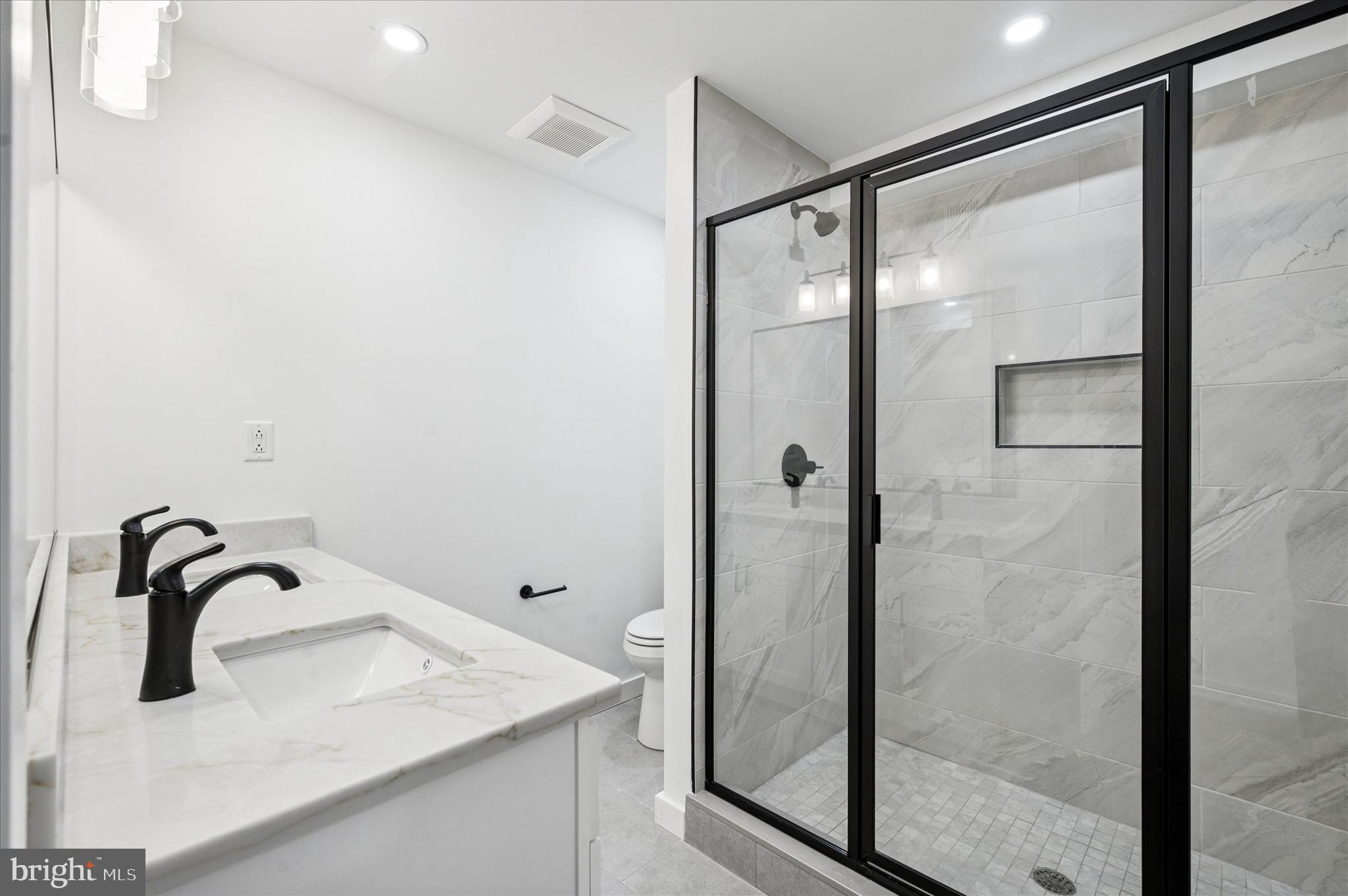 3408 Race Street, Unit 1 Philadelphia, PA 19104 - Photo 16 of 19 a bathroom with a granite countertop sink mirror and shower