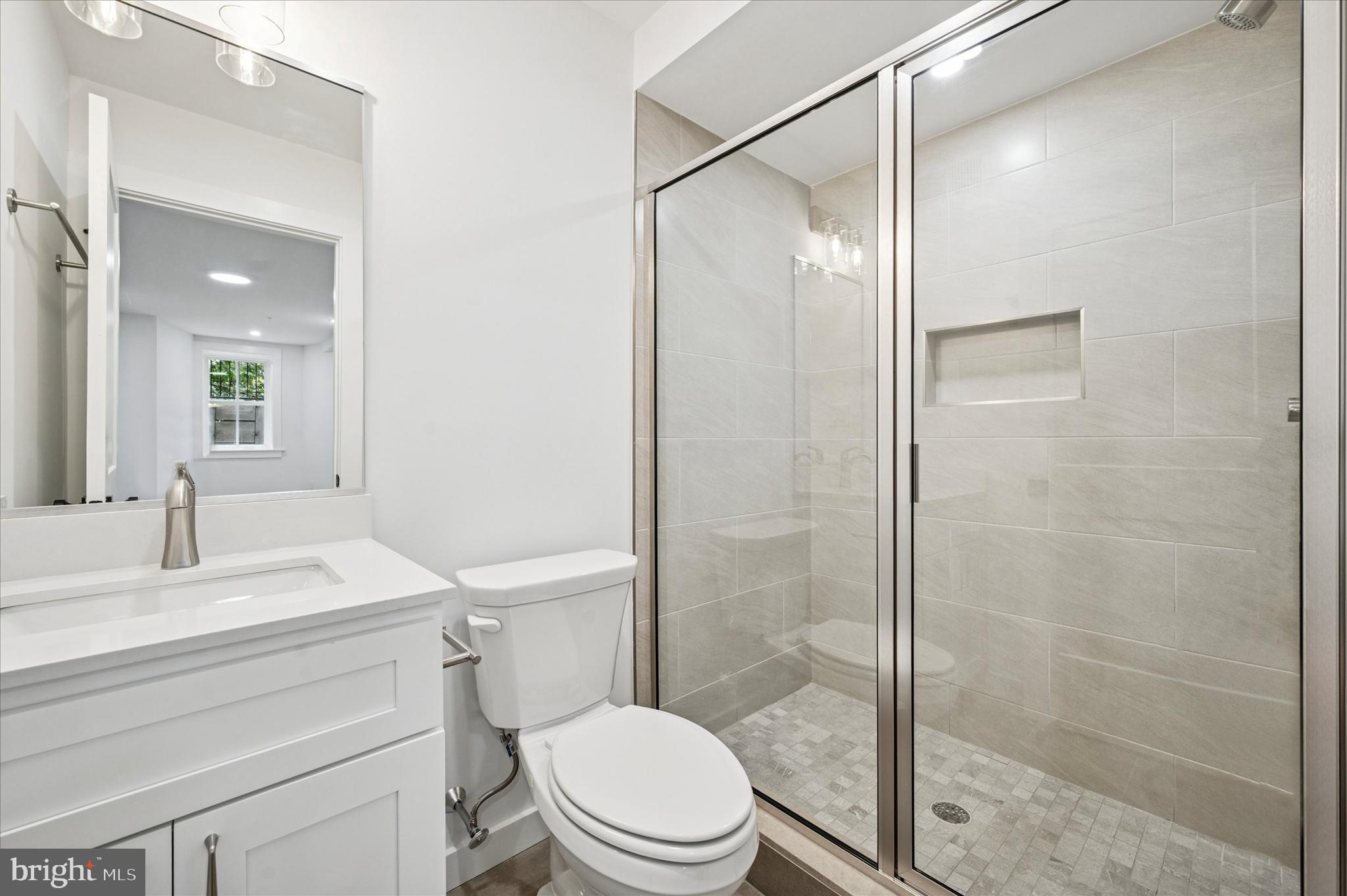 3408 Race Street, Unit 1 Philadelphia, PA 19104 - Photo 18 of 19 a bathroom with a sink a toilet and shower