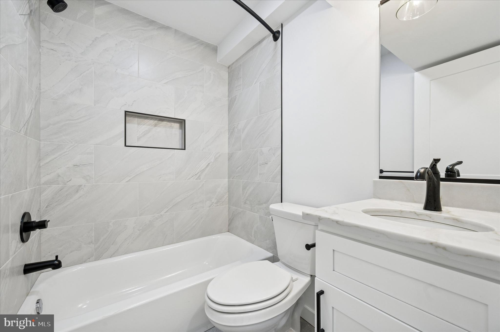 3408 Race Street, Unit 1 Philadelphia, PA 19104 - Photo 10 of 19 a bathroom with a sink a toilet and a bathtub