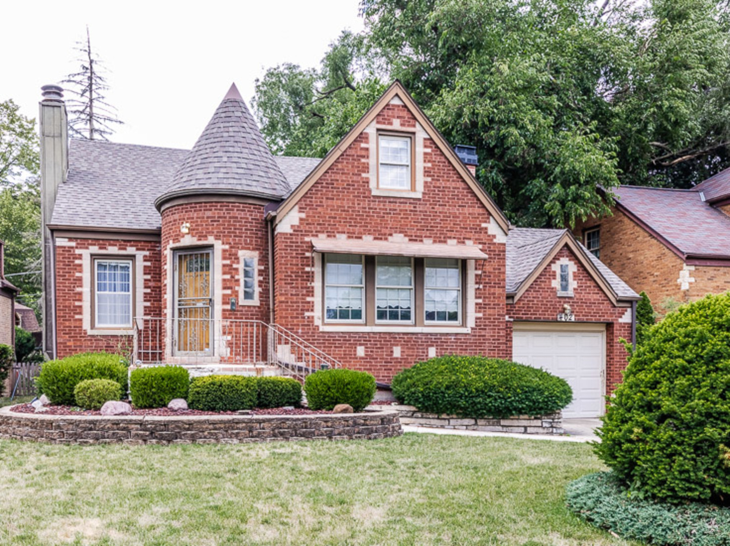 402 Longcommon Road Riverside, IL 60546 - Photo 1 of 48 a front view of a house with a yard and potted plants