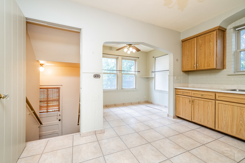 402 Longcommon Road Riverside, IL 60546 - Photo 13 of 48 a view of a kitchen with an empty space and a window