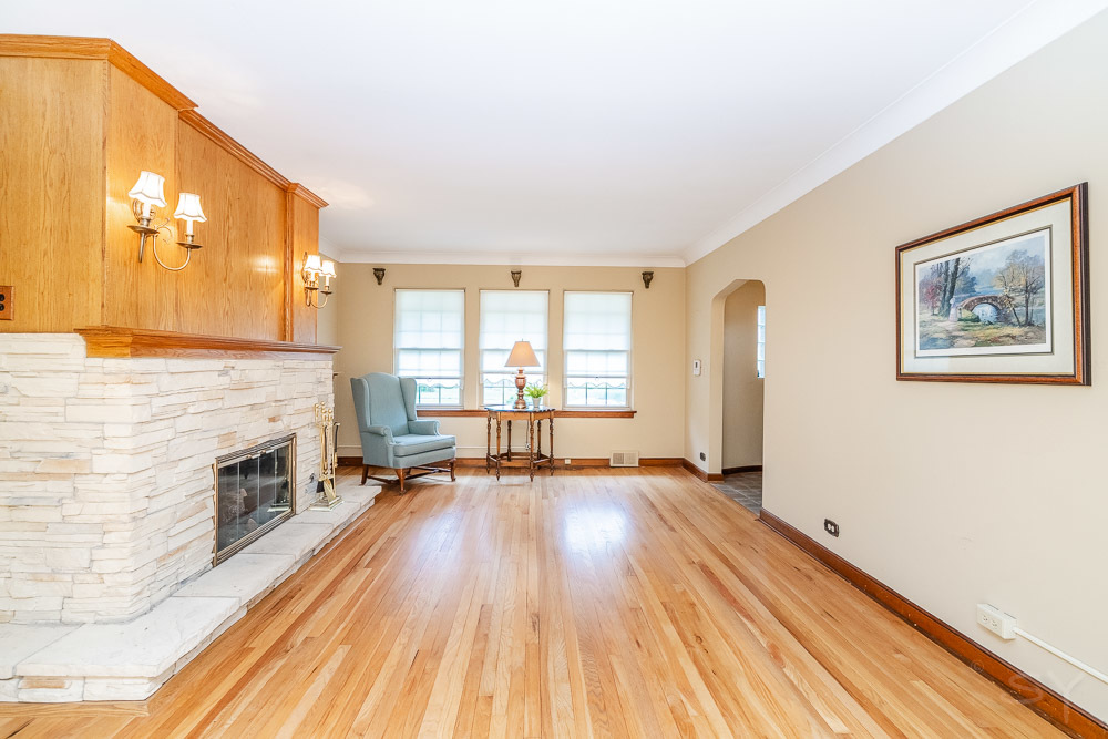 402 Longcommon Road Riverside, IL 60546 - Photo 3 of 48 a view of an empty room with a fireplace and a window