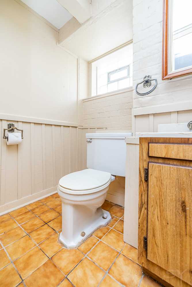 402 Longcommon Road Riverside, IL 60546 - Photo 38 of 48 a bathroom with a toilet a sink and a window