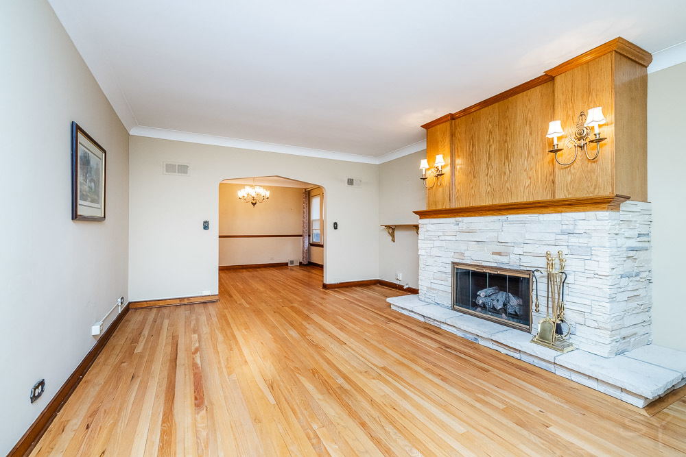 402 Longcommon Road Riverside, IL 60546 - Photo 4 of 48 a view of empty room with wooden floor and fireplace