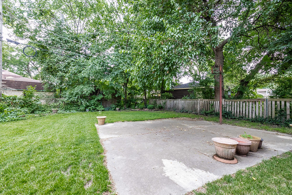 402 Longcommon Road Riverside, IL 60546 - Photo 41 of 48 a view of a backyard with table and chairs and potted plants