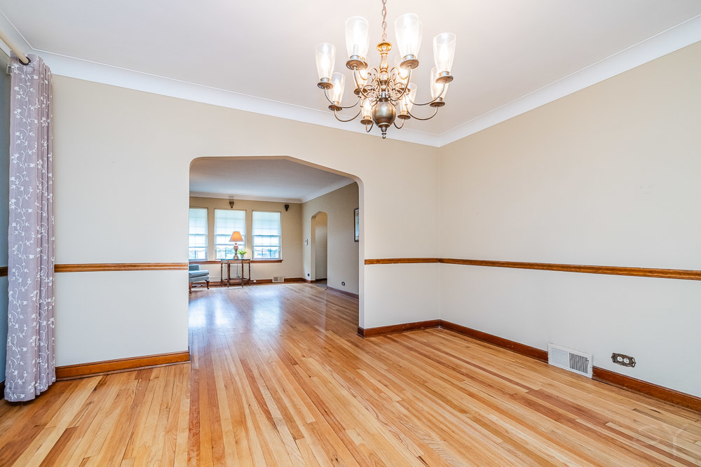 402 Longcommon Road Riverside, IL 60546 - Photo 7 of 48 a view of a room with wooden floor and chandelier