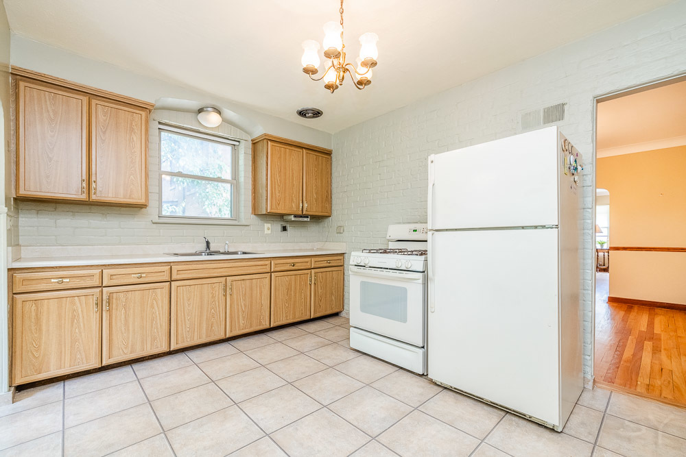 402 Longcommon Road Riverside, IL 60546 - Photo 9 of 48 a kitchen with granite countertop cabinets and white appliances