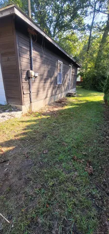 a backyard of a house with yard and outdoor seating