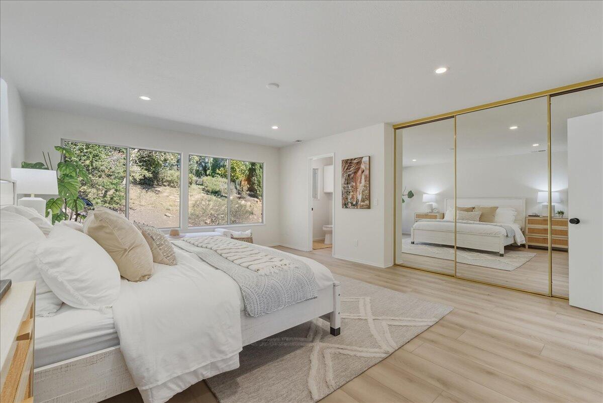 674 Chalk Hill Road Solvang, CA 93463 - Photo 12 of 52 a spacious bedroom with a bed a table and chairs