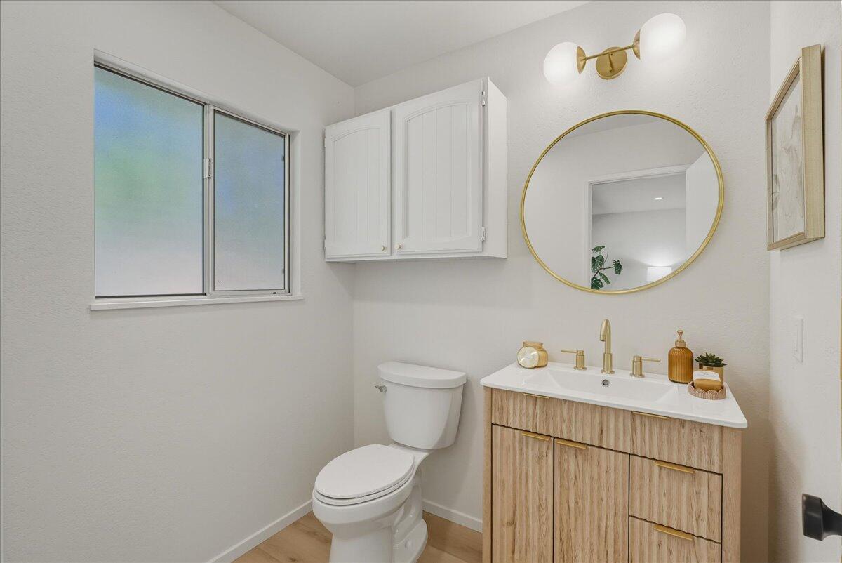 674 Chalk Hill Road Solvang, CA 93463 - Photo 14 of 52 a bathroom with a toilet a sink and mirror