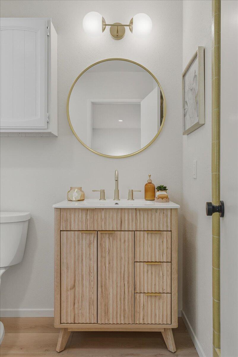 674 Chalk Hill Road Solvang, CA 93463 - Photo 15 of 52 a bathroom with a sink a toilet and a mirror