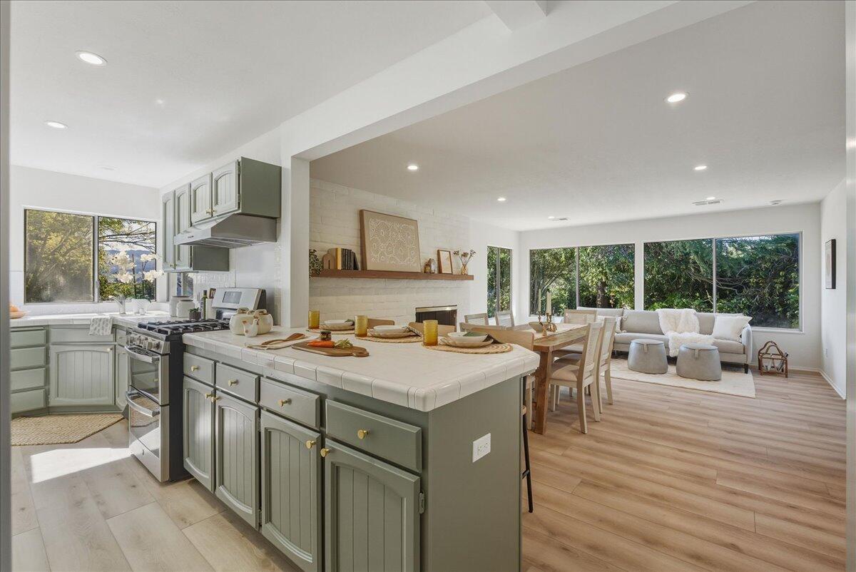 674 Chalk Hill Road Solvang, CA 93463 - Photo 24 of 52 a view of kitchen with stainless steel appliances granite countertop a stove top oven a sink dishwasher and couches with wooden floor