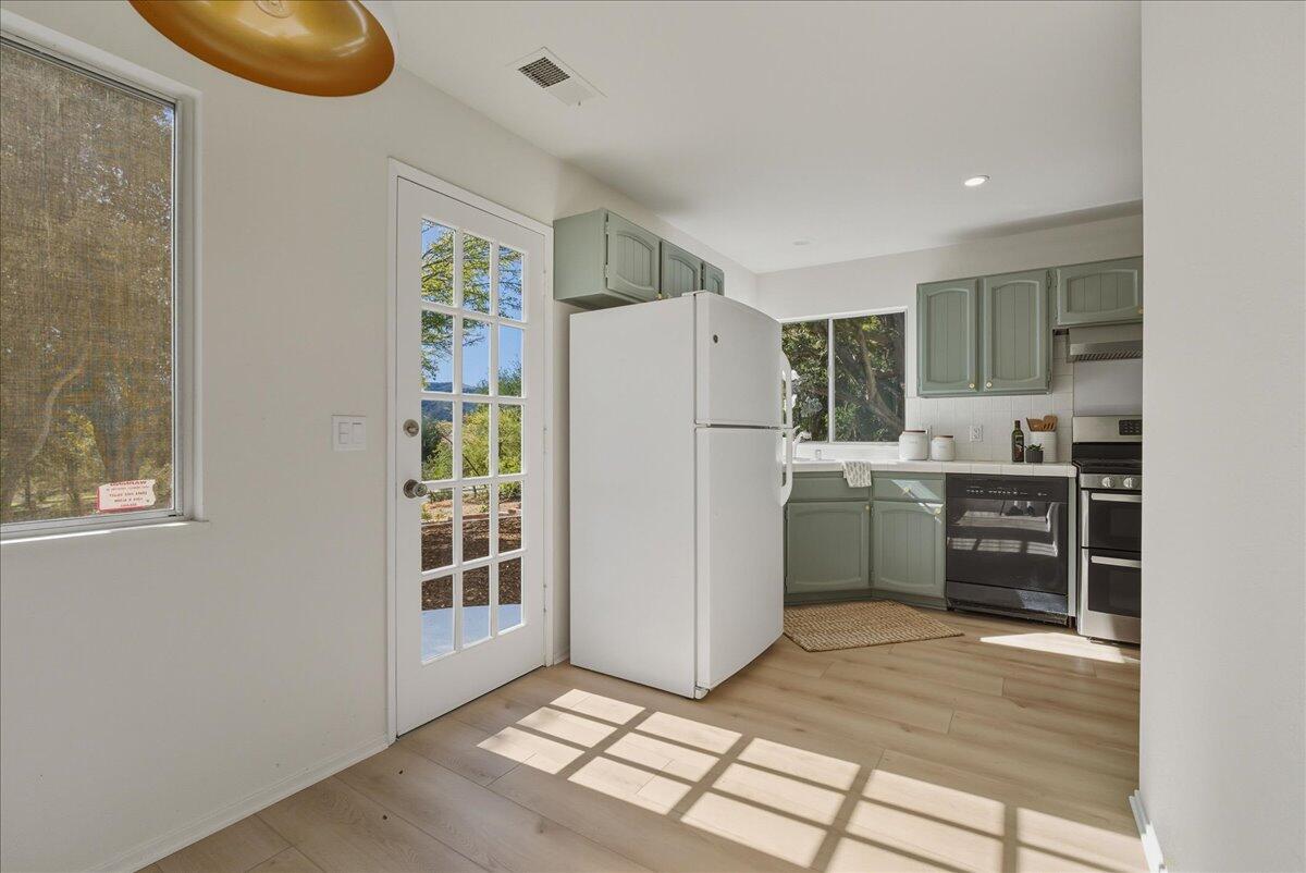 674 Chalk Hill Road Solvang, CA 93463 - Photo 29 of 52 a kitchen with a refrigerator a sink and a stove