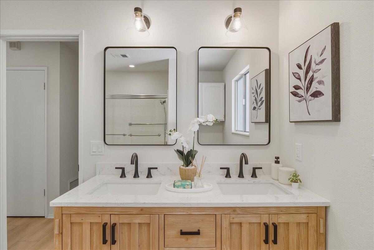 674 Chalk Hill Road Solvang, CA 93463 - Photo 33 of 52 a bathroom with double sink and a mirror