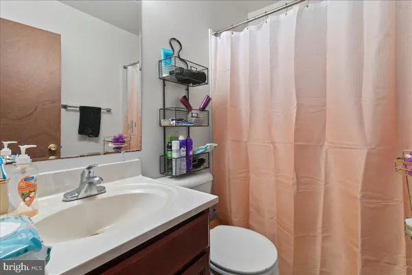 a bathroom with a sink vanity mirror and toilet