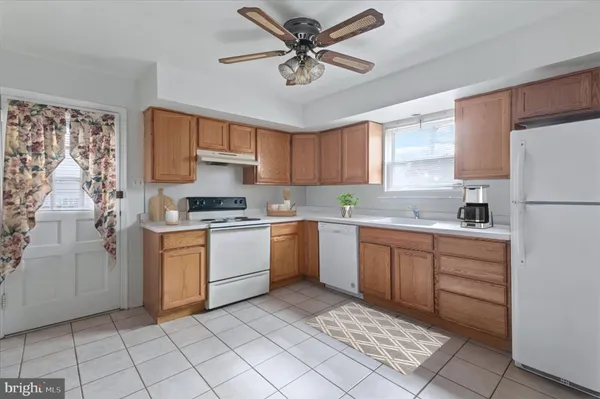 a kitchen with a stove a sink and a refrigerator