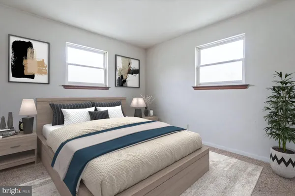 a bedroom with a bed and a potted plant