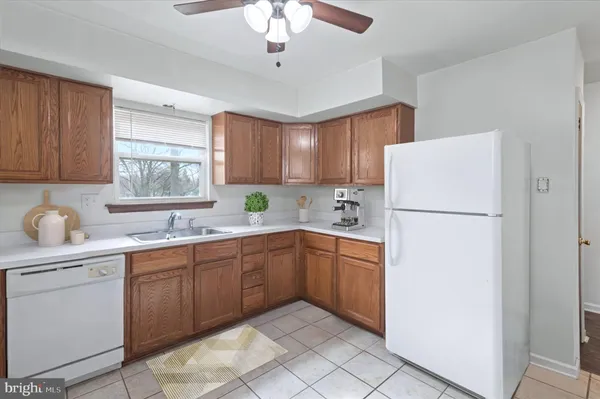 a kitchen with sink a refrigerator and cabinets